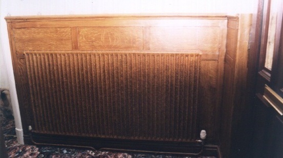 Bagging used to camouflage a radiator with oak graining